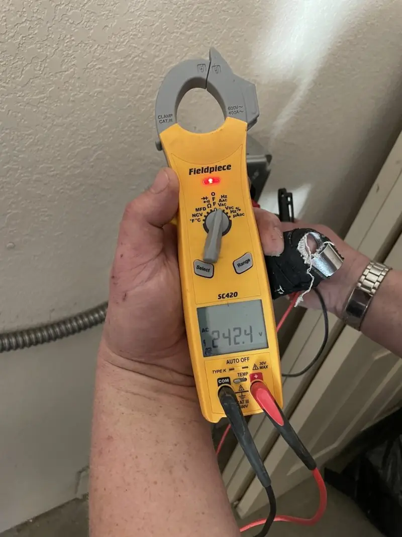 Voltage testing with clamp meter during Recessed Lighting Installation in Ripon